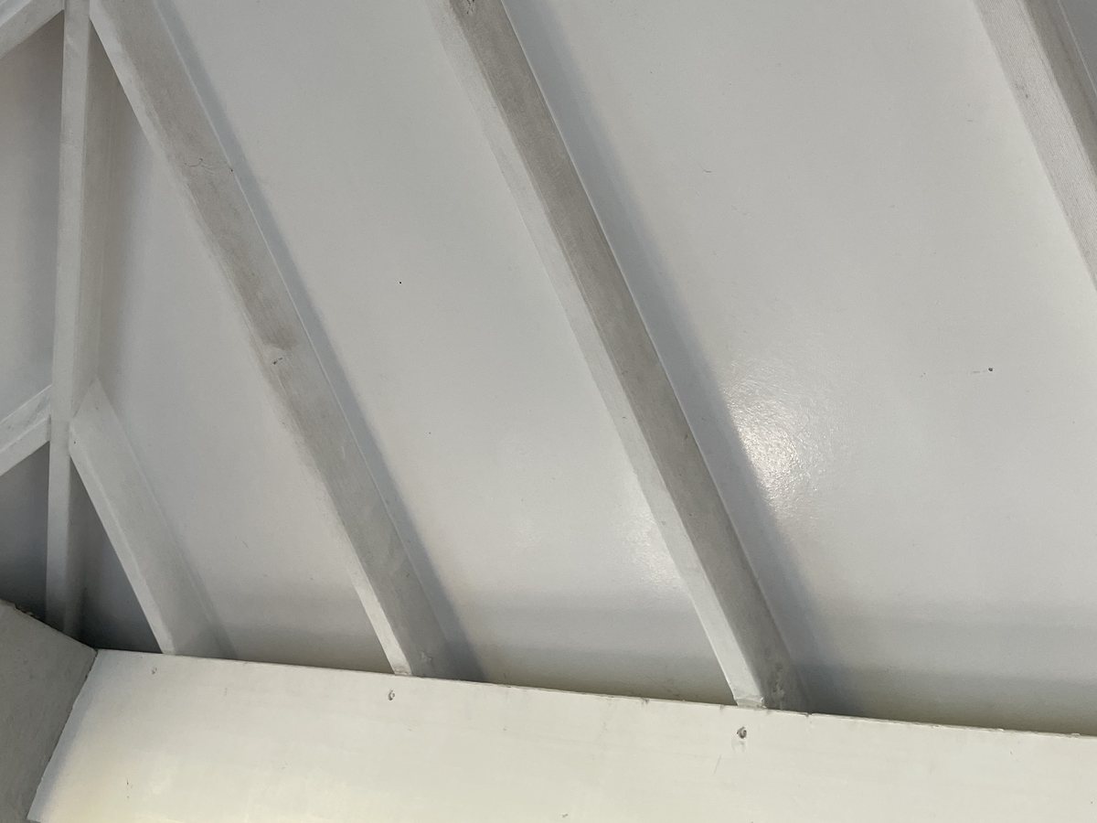 Patio roof lining before soft washing — grey mould streaks down the beams